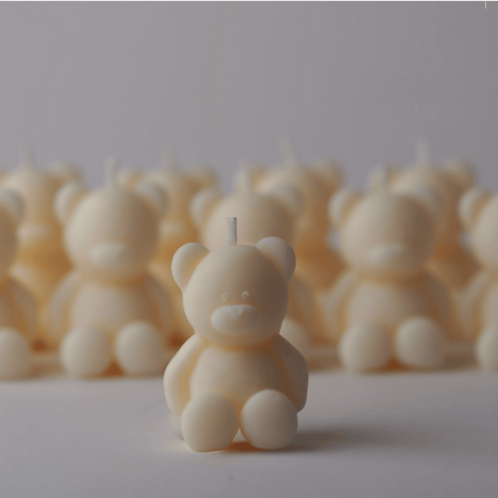 Bear-shaped candles on a white background